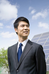 Portrait of a businessman in front of solar panels