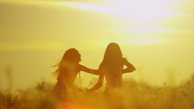 Caucasian Happy Young Sisters Love Friends Together Playing Outdoors Silhouette