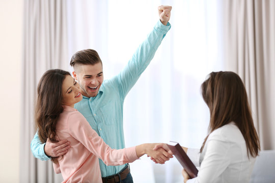 Woman shaking hands with estate agent in new home