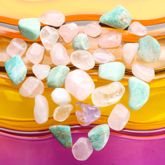 Heart shaped composition of semiprecious stones on bright background