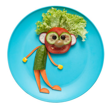 Funny fresh vegetable man on blue plate