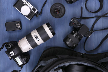 Photographer's equipment on a dark blue wooden background
