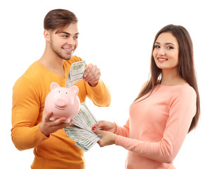 Couple pig money box and banknotes isolated on white