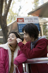 Young Couple Waiting At A Bus Station