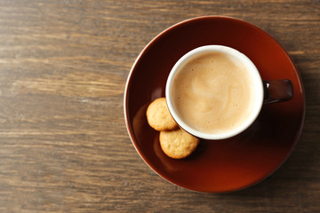 Cup of coffee on wooden background