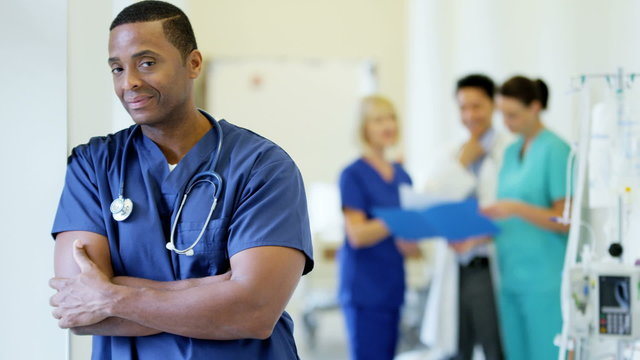 Portrait of confident African American male staff in medical centre corridor