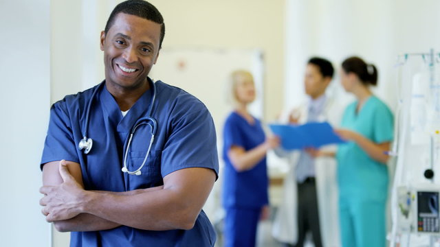 Portrait of confident African American male staff medical centre wearing scrubs