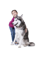 Cute little girl playing with a Husky dog