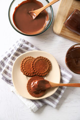 Melted chocolate onplate, on wooden background