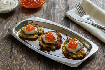 Potato pancakes (latkes)with yogurt and red caviar