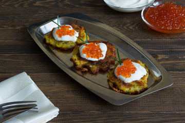 Potato pancakes (latkes)with yogurt and red caviar