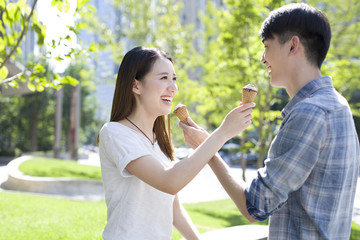 Happy young couple eating ice cream