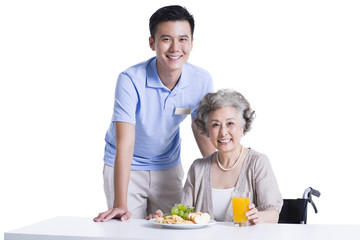 Disabled senior woman having breakfast in nursing home