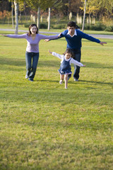 Young family playing in the park