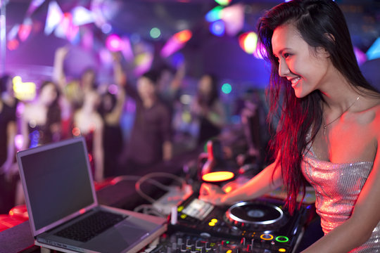 DJ doing record Scratching in nightclub
