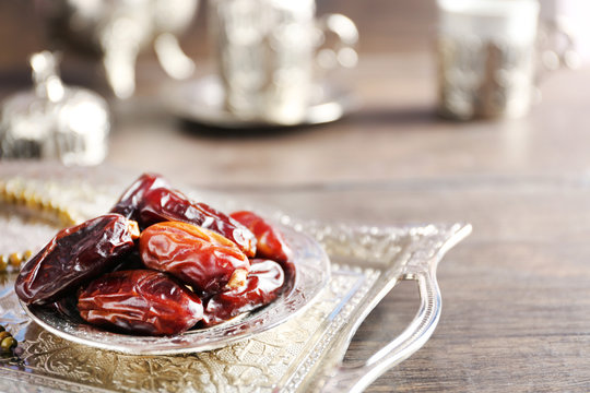 Dates fruit and rosary on beautiful tray, close up