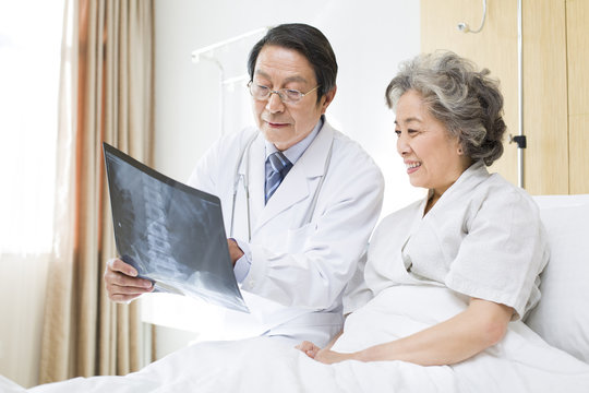 Doctor showing X-ray image to patient