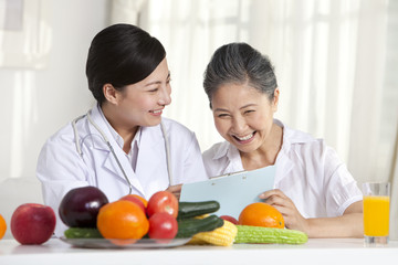 Family doctor showing a report to senior patient