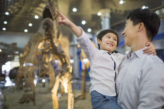 Young father and son in museum of natural history