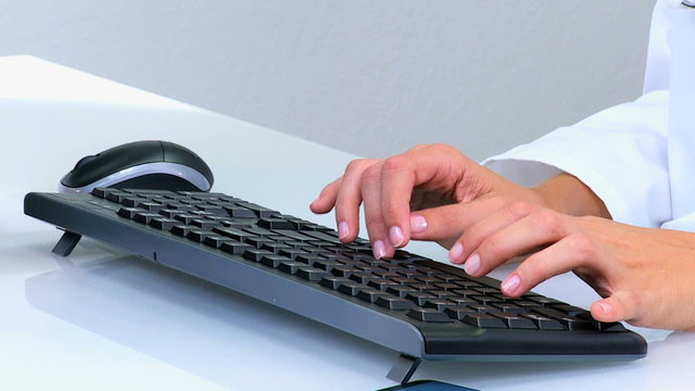 hands Caucasian Western female doctor consultant medical keyboard x-ray 