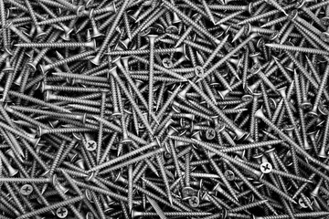 A lot of black screws close-up