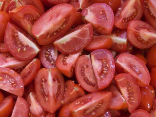 Chopped tomatoes background. Riped red tomatoes prepared for cooking italian style food close up.