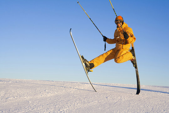 Young man playing around with ski equipment