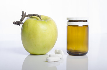 Apple with pharmaceutical product as concept of healthy living 