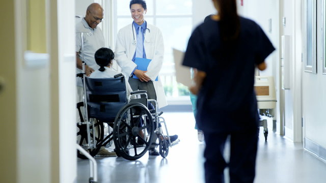 African American couple female on wheelchair consult with doctor in hospital