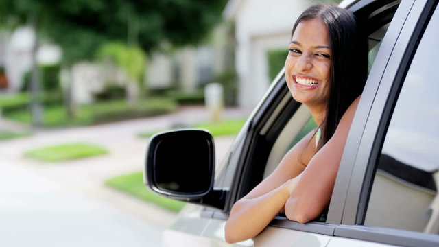Portrait of young happy Indian American girl driving first vehicle