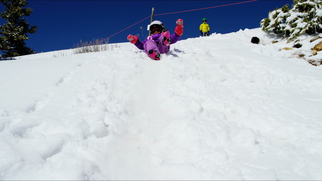 outdoor snow play Caucasian girl boy active Colorado winter vacation tourism 