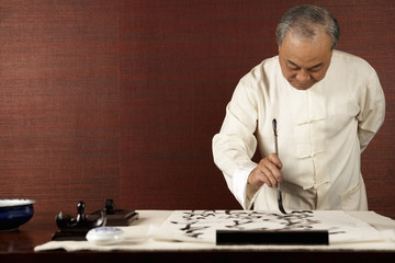 Elderly Man Practicing Calligraphy
