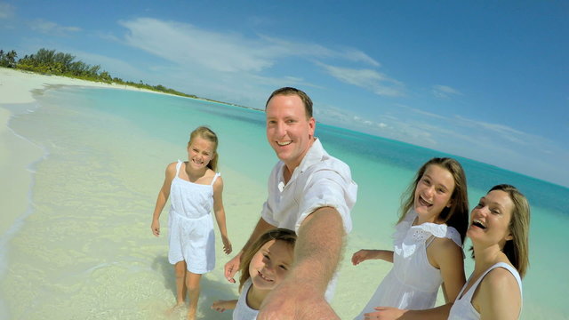 Selfie portrait of Caucasian family enjoying vacation beach 