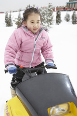 Young Girl Riding Snowmobile