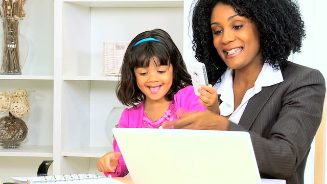 business female African American young child home laptop smart phone wireless