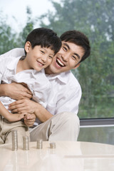 Obraz premium Father and son calculating coins