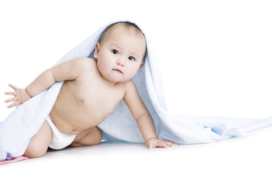 Cute baby boy wrapped in towel