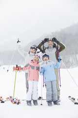 Young family skiing in ski resort