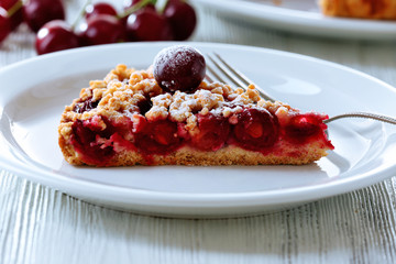 Tasty homemade pie with cherries on table close up