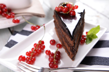 Tasty chocolate cake with berries on table close up