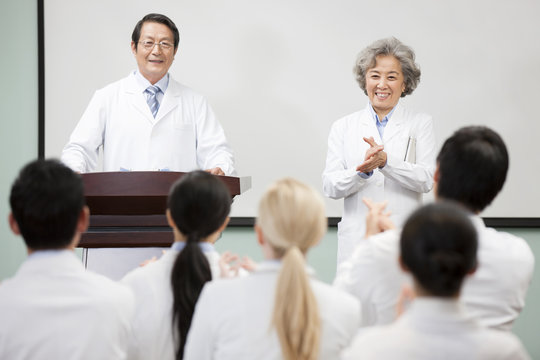 Medical workers clapping in a meeting