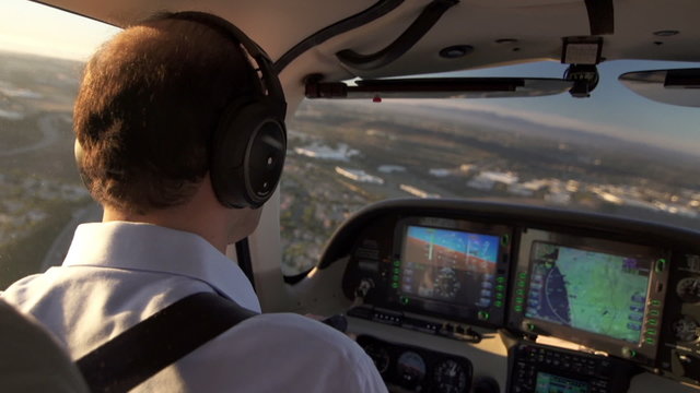 Airplane Pilot Flying Observes Navigation Control. Inside Cabin View.