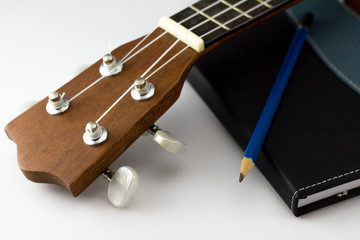 Notebook , pencil and Ukulele