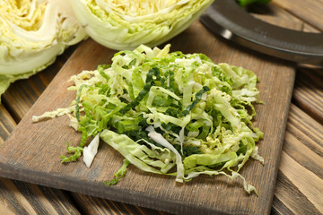 Cut savoy cabbage on wooden cutting board closeup