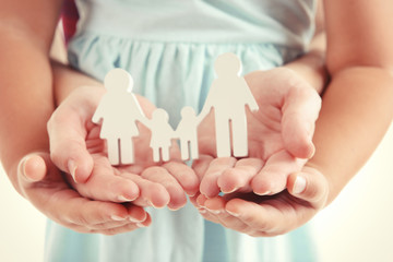 Concept of united family - figures of parents and kids in girls and mothers hands