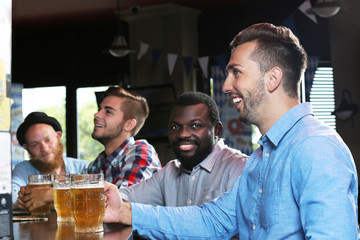 Young men drinking beer in pub