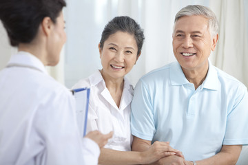 Family doctor examing senior patient