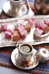 Obraz na płótnie Canvas Antique tea-set with Turkish delight on table close-up