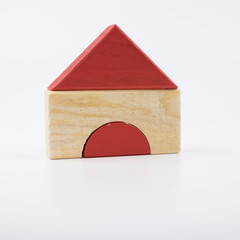 Obraz na płótnie Canvas The wooden house. Children's toys - wooden cubes on a white background