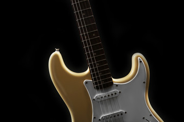 Fototapeta na wymiar Part of white electric guitar, on black background